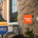 A well-lit front door with a SimpliSafe security system keypad mounted on the wall, illustrating home security for Consumer Cellular customers.