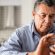 A man confidently using a smartphone while reviewing or blocking an incoming call, representing how to identify, block, and prevent spam calls and texts using simple mobile phone safety tips.