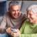 Consumer Cellular logo alongside lifestyle image of people holding a phone.